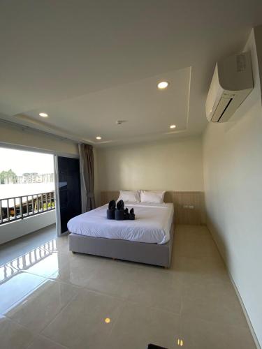 a bedroom with a bed with two teddy bears on it at The Terraza A312 - Cozy Apartment in Amphoe Koh Samui