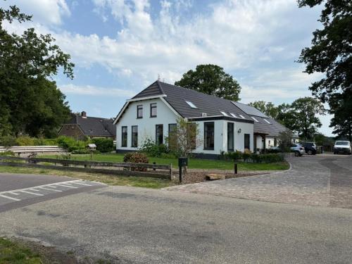 a white house on the side of a road at 't Veurhuus in Ansen