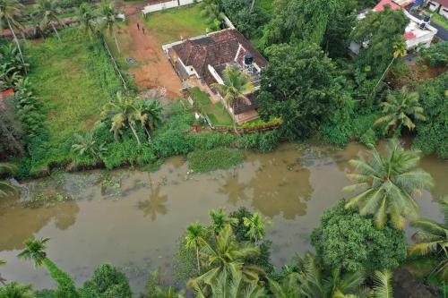 an aerial view of a house next to a river at Ra Ga Riverside - 2 Bedroom Retreat in Kumarakom