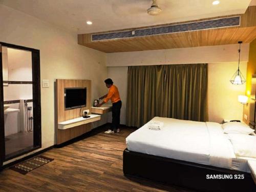 a man is standing in a hotel room at The Four Seasons Recreation in Jālgaon