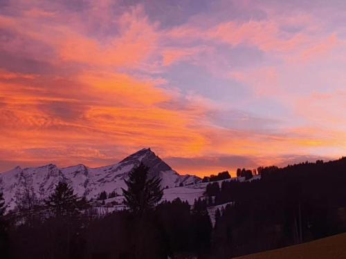 a sunset with a snow covered mountain in the background at Apartment in Trans Village in Trans