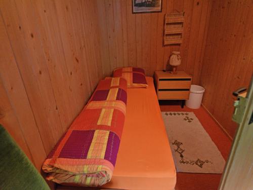 a room with a bed in a wooden room at Apartment in Trans Village in Trans