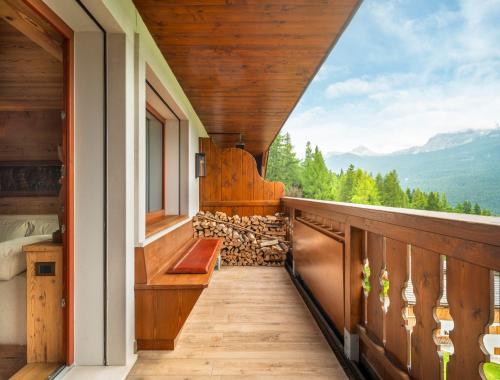 a balcony with a view of the mountains at Tablà del Bosco R&R in Cortina dʼAmpezzo