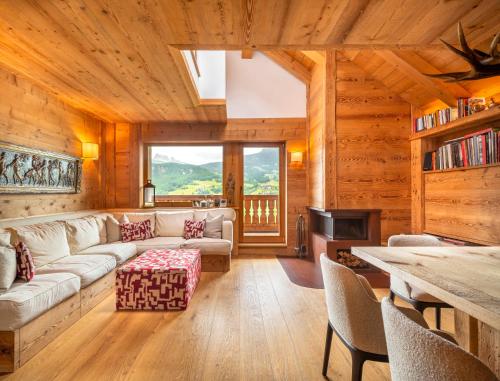 a living room with a couch and a table at Tablà del Bosco R&R in Cortina dʼAmpezzo