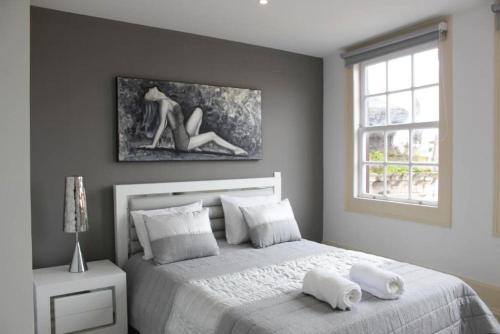 a bedroom with a bed with white pillows and a window at Sunday Lovers - FB - 96 in Coimbra