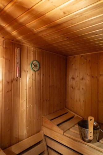 a wooden sauna with a clock on the wall at Haus Ferienglück in Thalfang