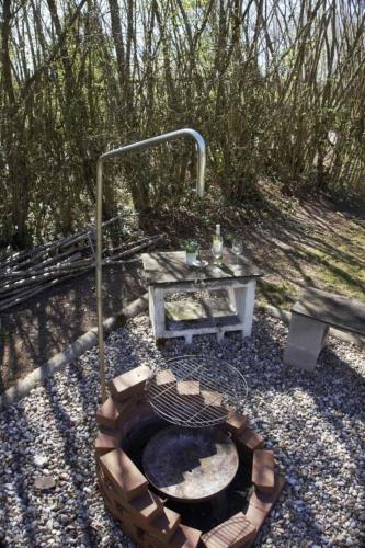 a fire pit in the middle of a garden at Haus Ferienglück in Thalfang