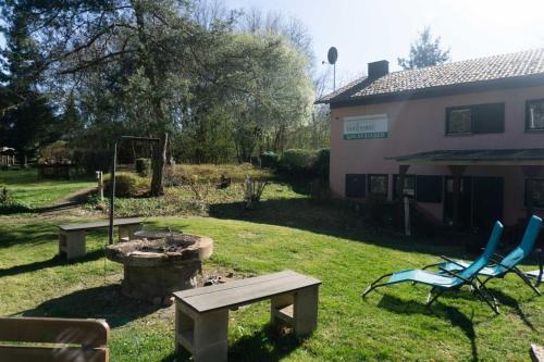 ThalfangにあるHaus Waldfrieden EGのピクニックテーブルと椅子付きの庭