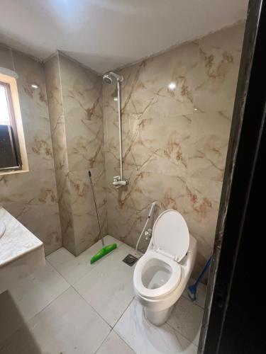 a bathroom with a toilet in a room at Guest house in Karachi