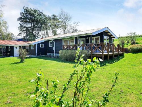 a house with a large yard in front of it at 5 person holiday home in Stege in Stege
