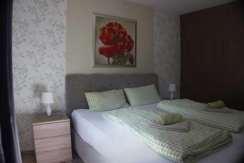 a bedroom with two beds and a painting on the wall at Haus Im Wiesengrund OG in Thalfang