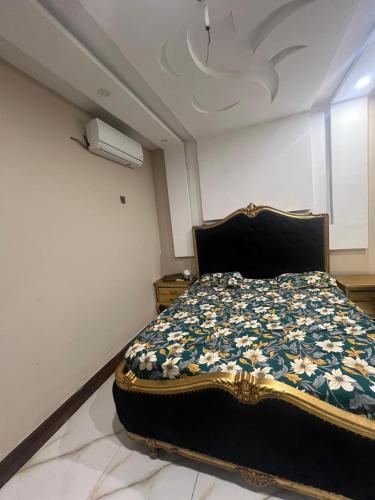 a bedroom with a bed in a room with a ceiling at Guest house in Karachi