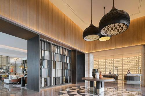 a lobby with two pendant lights and a table at Courtyard by Marriott Korla in Korla