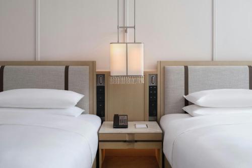 two beds sitting next to each other in a room at Courtyard by Marriott Korla in Korla
