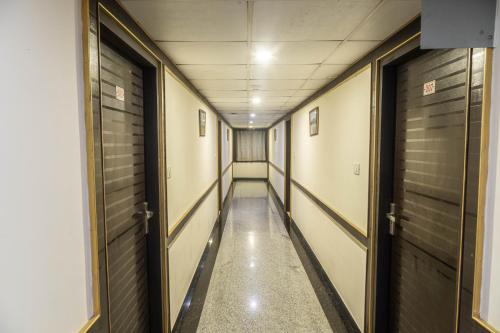 a corridor of a hallway with two doors at Hotel Comfort Park - Opposite Sri Ramachandra Medical College Porur in Chennai