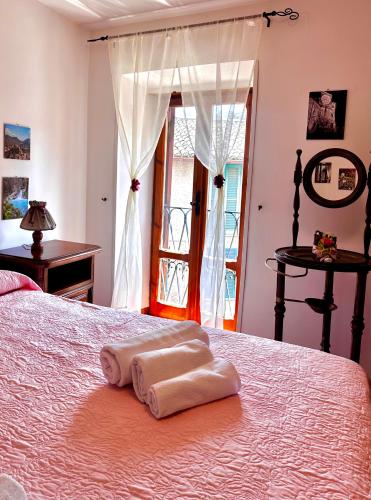 a bedroom with a bed with two towels on it at LA GROTTA Guest House Subiaco in Subiaco