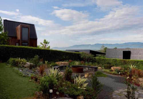 a garden in front of a house at The CAMPIAN in Chiang Mai