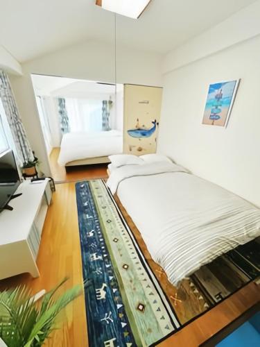 a bedroom with a large bed and a desk at Louis House Otsuka Nishi in Tokyo