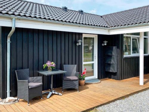 a patio with chairs and a table on a deck at Spacious Family Retreat - By Traum Ferienwohnungen in Hals