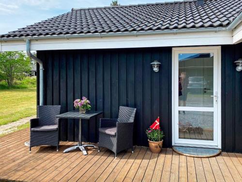 a patio with two chairs and a table on a deck at Spacious Family Retreat - By Traum Ferienwohnungen in Hals