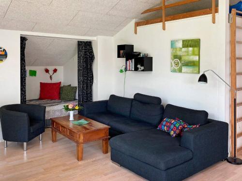 a living room with a blue couch and a table at Spacious Family Retreat - By Traum Ferienwohnungen in Hals
