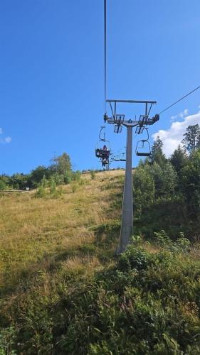 an empty ski lift on a hill in a field at Ferienwohnung Pfeiffer groß in Sankt Andreasberg