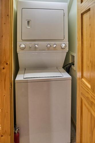 a white stove in a room with a door at Simply Heaven in the Smokies By Avada Properties in Wear Valley