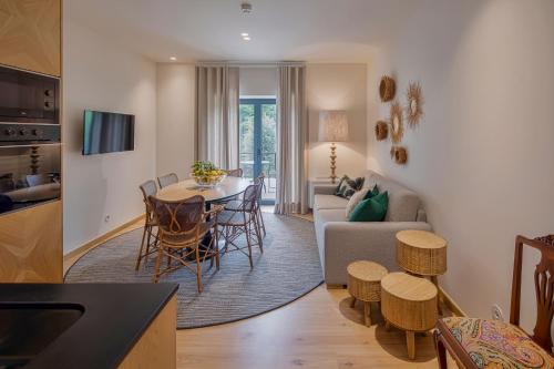 a living room and kitchen with a table and chairs at Casa do Rio in Mondim de Basto