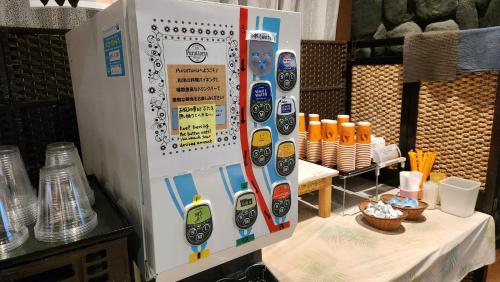 a refrigerator with stickers on it next to a table at APA Hotel Saga Ekimae Chuo in Saga