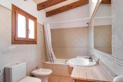 a bathroom with a toilet and a sink at Finca Peris in Caʼs Concos
