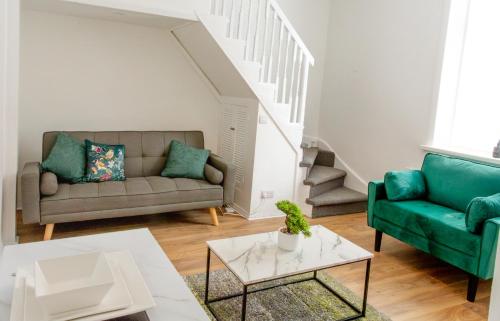 a living room with a couch and a table at A modern cosy 2 bed Gateshead Newcastle house in Gateshead