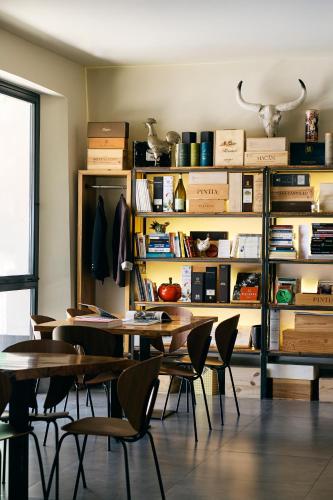 a dining room with tables and chairs and bookshelves at The Corner House in Seville