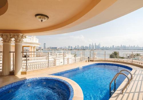 a swimming pool on a balcony with a view of the city at Kempinski Hotel & Residences Palm Jumeirah in Dubai
