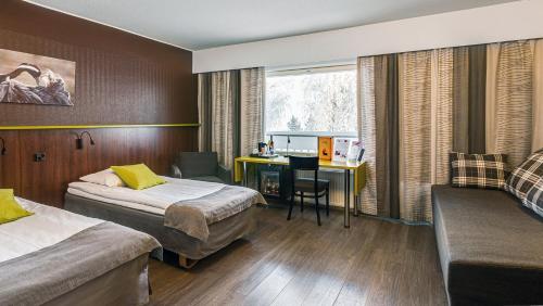a hotel room with two beds and a desk at Finlandia Hotel Airport Oulu in Kempele