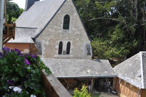 a church with bikes parked in front of it at Au Château des Ifs in La Haye-de-Routot