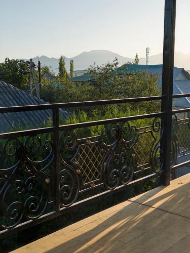 a black iron fence on a balcony with a view at Cholpon Guest House & Hostel in Toktogul