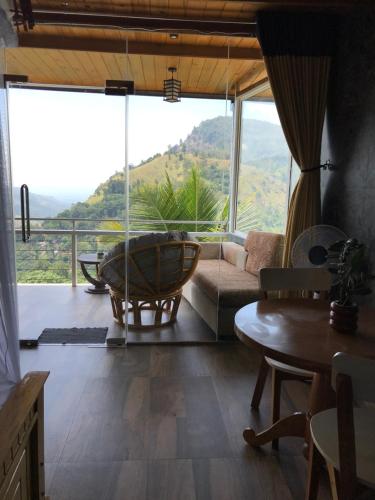 a living room with a couch and a table at Ella HIDE VIEW in Ella
