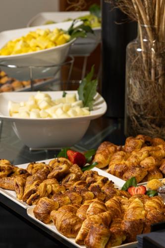 a display of food on a table with plates of food at Crowne Plaza Milan Linate by IHG in San Donato Milanese