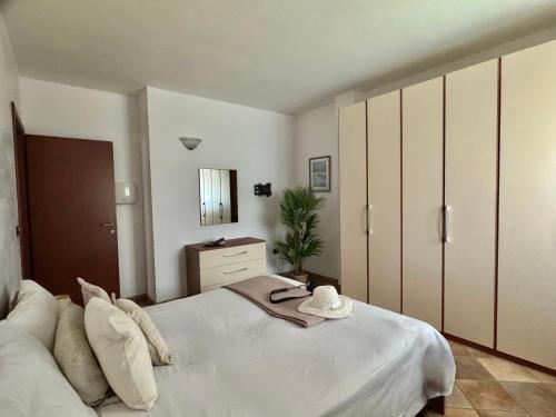 a bedroom with a large white bed and a mirror at Casa Paola vista mare - Starlink in Specchiolla 