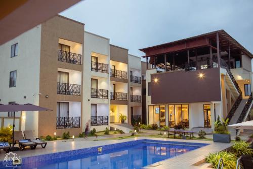 an exterior view of a hotel with a swimming pool at AIDEN HOMES AND APARTMENTS HOTEl in Koforidua