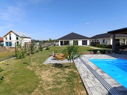 a backyard with a swimming pool and a house at Apartmán na Slovácku in Uherské Hradiště