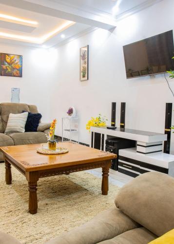a living room with a coffee table and a flat screen tv at Naivasha Vacation Homes - Villaview in Naivasha