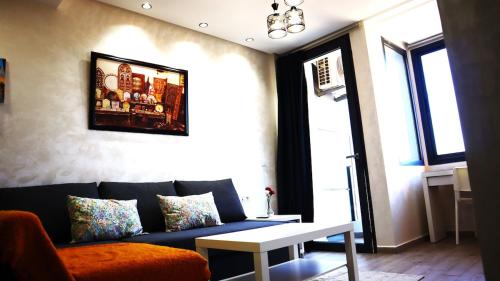 a living room with a blue couch and a table at Beautiful and cosy apartment in Casablanca