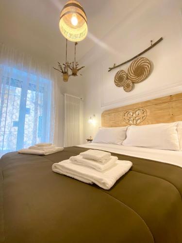 a bedroom with two beds and a chandelier at Il Re degli Scalzi in Matera