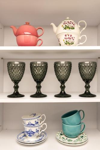 a shelf with cups and tea pots on it at stay DAHOM in Seoul