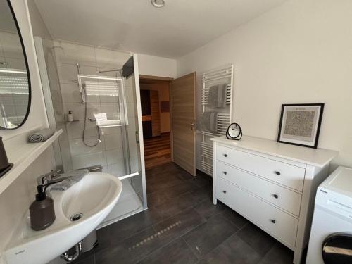 a bathroom with a sink and a shower at bella casa Allgäu Apartment 5 in Bad Wörishofen