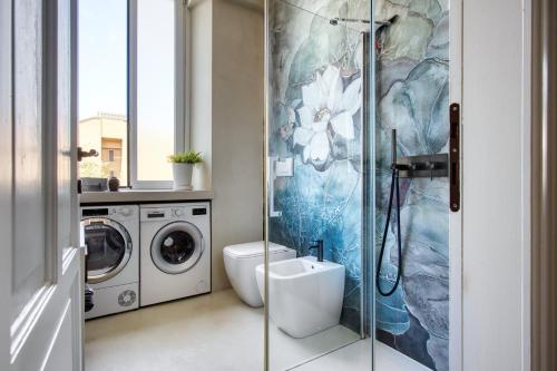 un bagno con WC e lavatrice di Design & Dine a Milano