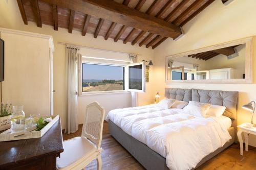 a bedroom with a large bed and a window at CASALE DEI GELSOMINI 8, Emma Villas in Todi
