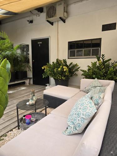 a white couch with pillows on a patio at Nice Life apartments in Willemstad