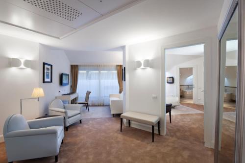 a living room with a mirror and a room at Maison Milano | UNA Esperienze in Milan